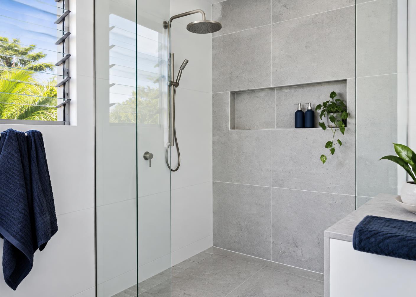 Walk-in shower with clean tiled walls where regrouting can avoid re-tiling